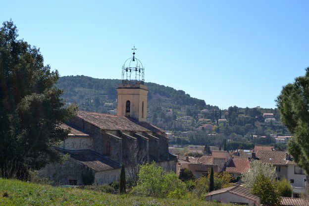 Notre-Dame de l'Assomption church in Le Beausset with its typical Provençal wrought-iron campanile against the Var hills